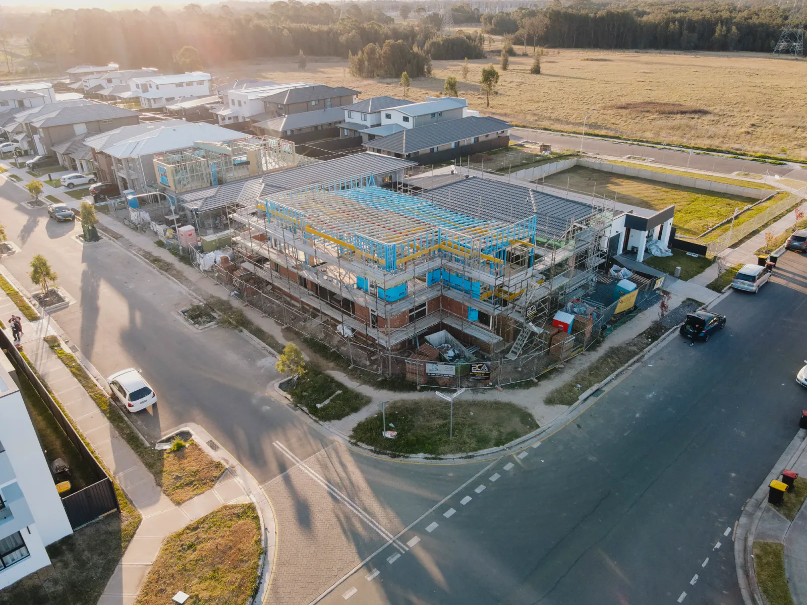 Large two-storey residential project under construction at golden hour