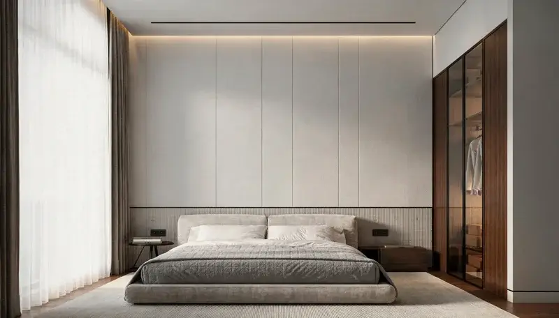 Bedroom with textured wall panels and illuminated timber wardrobes