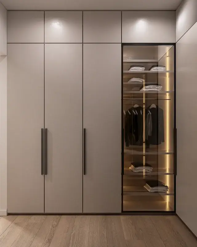 Bespoke wardrobe with glass fronted shelving and dark handles